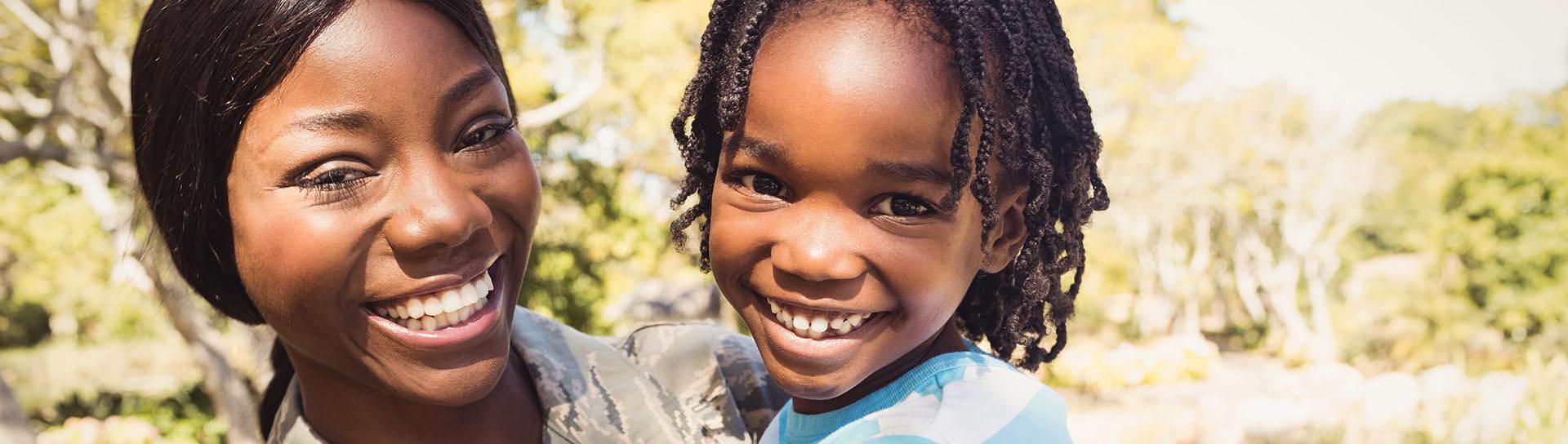 Military veteran and child smiling - Tulane SoPA