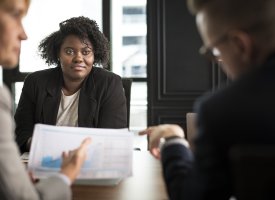 A group of people in a meeting