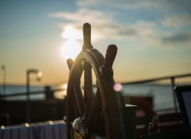 Ship steering wheel on a boat - Tulane School of Professional Advancement