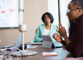 IT Professionals talking around a table - Tulane School of Professional Advancement