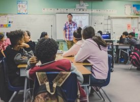 Students in a classroom looking at the teacher - Tulane School of Professional Advancement