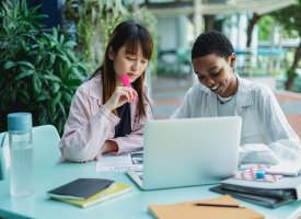 Two students working together at a table