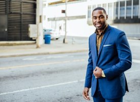 A man walking down a street in a business suit