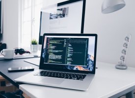 A laptop with coding on the screen