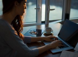 A person on a laptop representing test-taking tips for online learners by Tulane School of Professional Advancement in New Orleans, LA