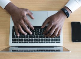 A person typing on a laptop