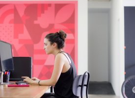 A woman typing on a computer