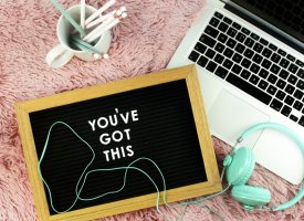 A chalkboard next to a laptop that says 'You've Got This'