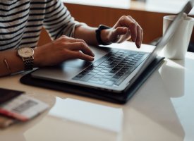 A person typing on a laptop