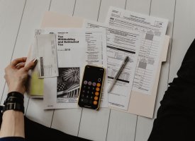 A person with a folder of financial documents