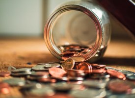 A jar with change spilling out of it