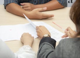 People during an interview going over a resume