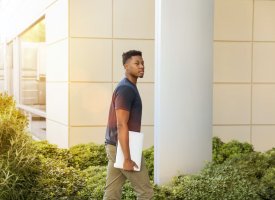 Transfer student walking on university campus - Tulane School of Professional Advancement